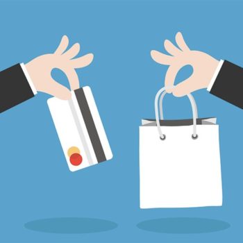 Two hands holding a shopping bag and credit card, showcasing the convenience of online shopping and secure payment options.