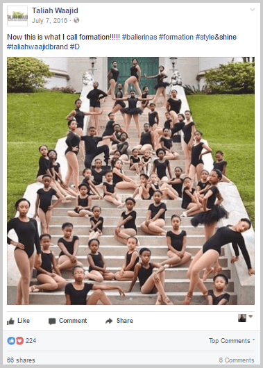 A group of dancers are striking stylish poses on the steps of a building.
